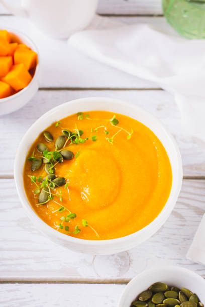 istock Corn porridge with pumpkin puree and microgreens in a bowl on the table vertical view 1814754463