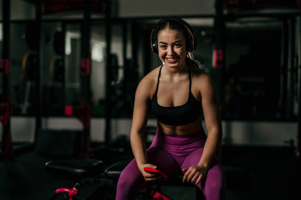 istock Woman in gym lifting heavy weights. 1814756097