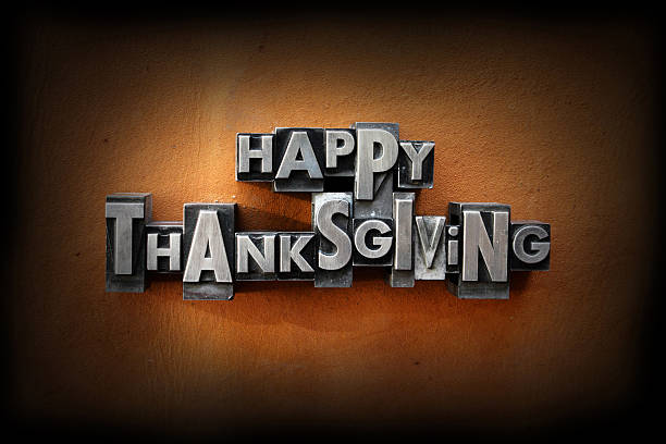 Happy Thanksgiving The words Happy Thanksgiving made from vintage lead letterpress type on a leather background. typescript print letterpress block stock pictures, royalty-free photos & images