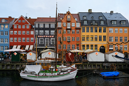 Scenic winter view of Nyhavn pier with colorful buildings and boats on December 24, 2019 in Old Town of Copenhagen, Denmark