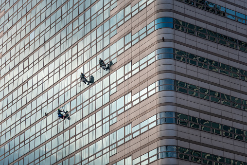 Workers cleaning windows of a skyscraper in Seoul, capital of South Korea