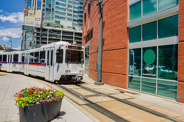 istock Light rail train traveling through a sun filled city 181479385