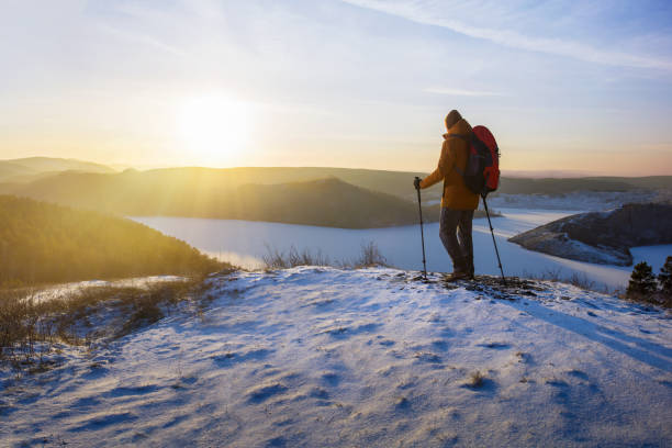 istock man with backpack hiking mountains at winter season. freedom activity lifestyle. 1814796540