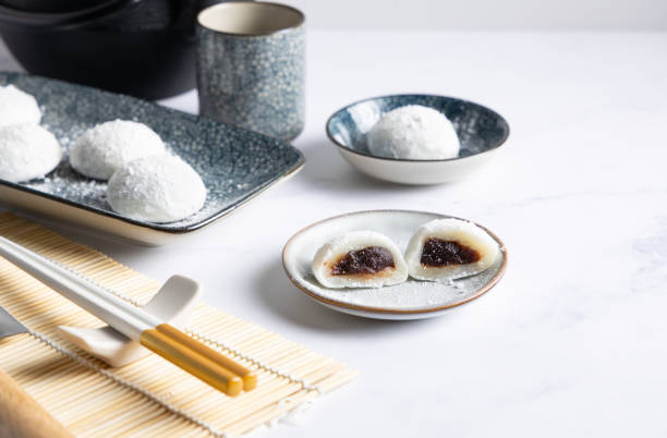 Red bean Mochi. Japanese rice cake with a red bean filling, delicious Japanese sweet called Mochi on a Japanese style table top. red bean dessert stock pictures, royalty-free photos & images
