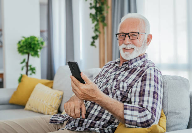 istock Senior man using smart phone at home 1814810723