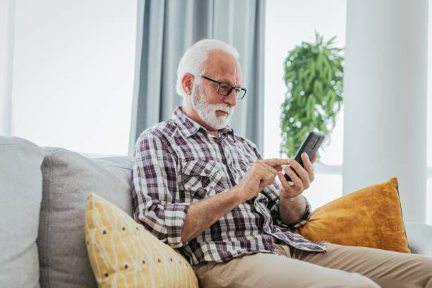 istock Senior man using smart phone at home 1814810724