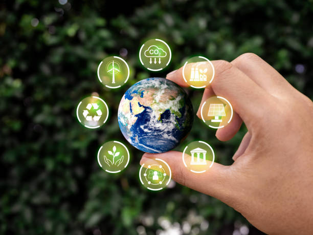 istock Reduce CO2 emissions, world and environmental sustainability care, net zero carbon dioxide reduction concept. Small earth hold by hand with green renewable energy and ESG icons on leaves background. 1814817974