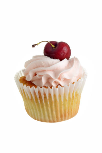 cherry buttercream cupcake with fruit on white