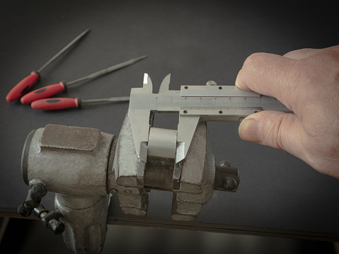 Measuring a workpiece held in a vise with a caliper