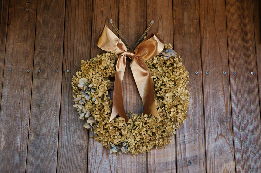 Autumn winter inspired dry wreath displayed on the wall