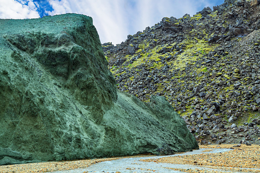 Picturesque huge stone covered with green moss. Landmannalaugar. Rhyolite mountains and streams. Amazing Iceland - dream for photographers and tourists