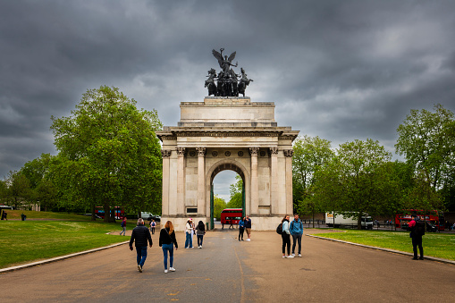 London, United Kingdom - June 2, 2023:  Some people walking near Wellington Arch at Hyde Park in London.