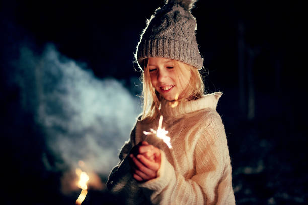 istock Girl Looking at Sparkler 1814867898