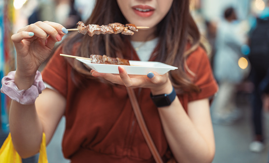 Close-up group of friend people enjoying grilling becon pork and Wagyu A5 beef Yakiniku with japanese lunch set in Kyoto Japan