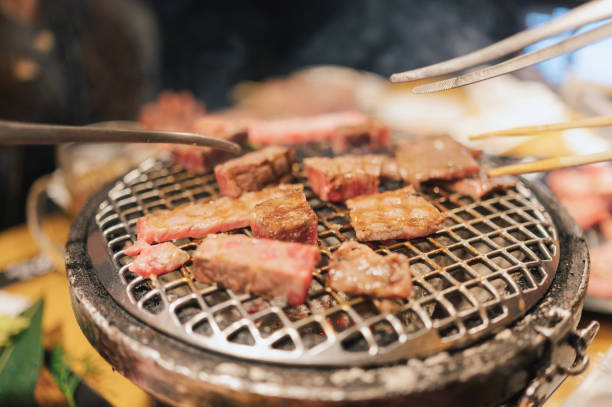 Asian tourist women eating Yakiniku Wagyu A5 and most expensive meat at osaka japan