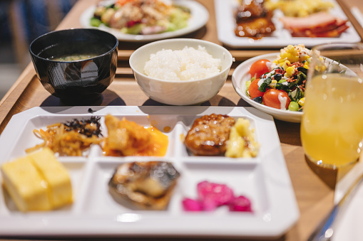 Western and japanese fusion brunch serve on plate with decoration with vegetable coffee bread in japan