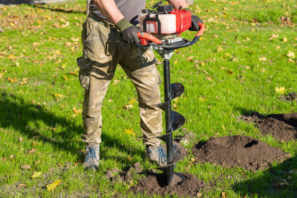 istock Gardener using tools hand-held soil hole drilling machine or portable manual earth auger. 1814879122