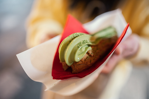 Close-up asian bite Matcha cream puff ice cream in kyoto japan