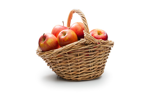 Basket with crisp apples isolated against white background