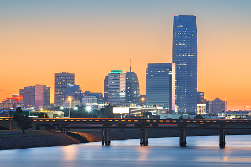 Oklahoma City, Oklahoma, USA downtown skyline on the Oklahoma River at dawn.