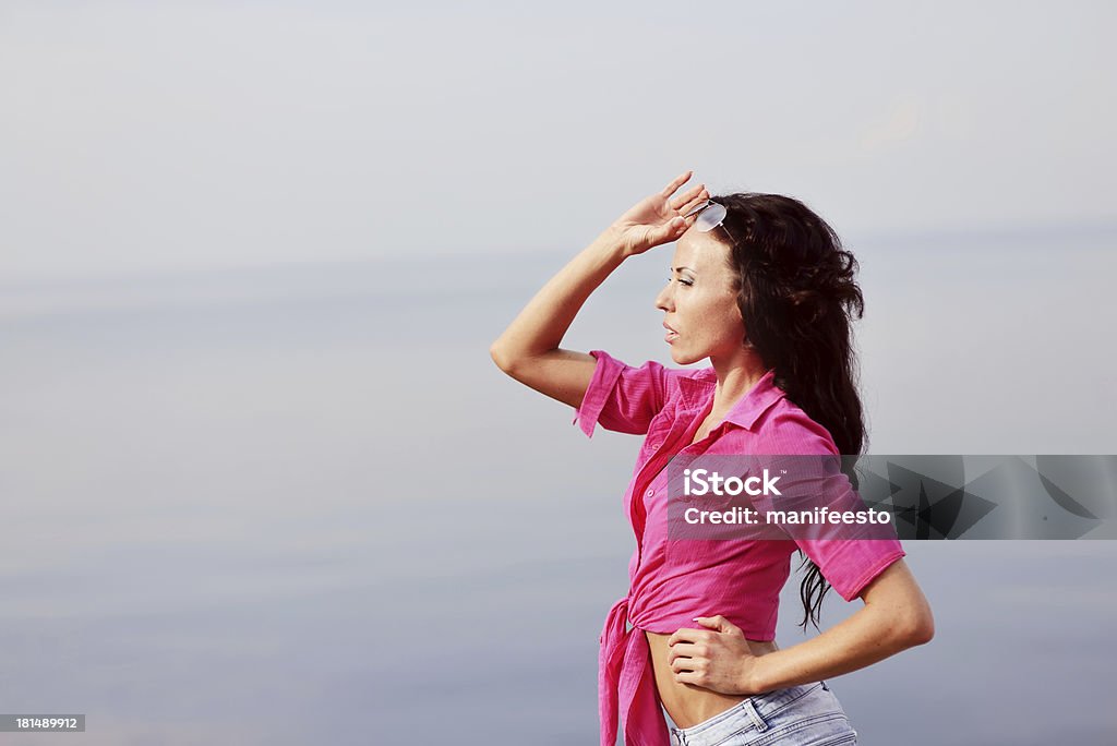 Giovane brunette indossa camicia rosa da mare - Foto stock royalty-free di Acqua