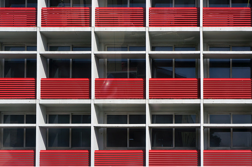 Red Balconies of Modern Multistorey Building. Fragment of Facade. Architectural Background.