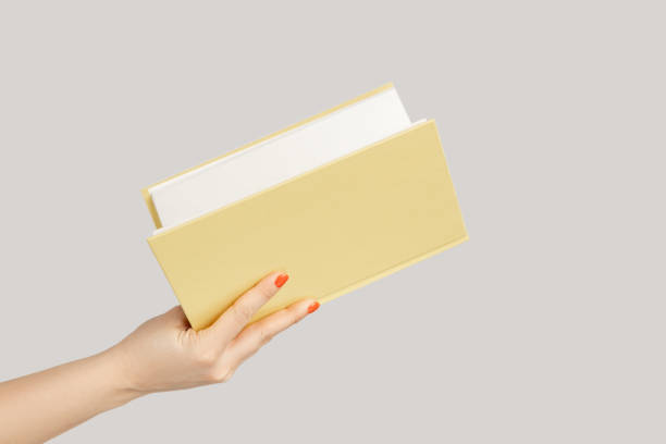istock Woman hand holding open book or organizer. 1814900792