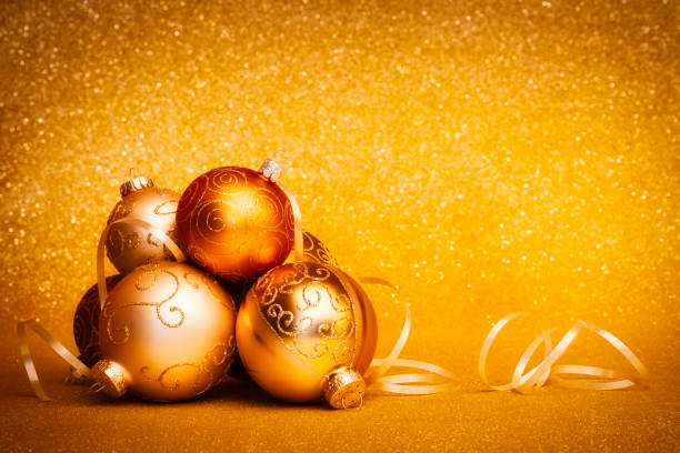 Golden Christmas Baubles on glitter background