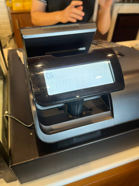istock An employee is using a cash register for a customer in a cafe. 1814901255