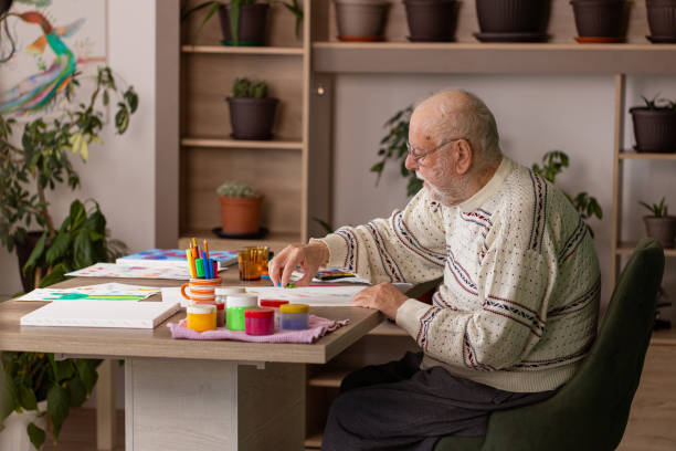 istock Male artist paints on a canvas in his studio 1814901319