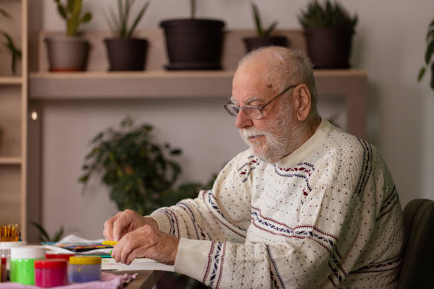 istock Male artist paints on a canvas in his studio 1814901333