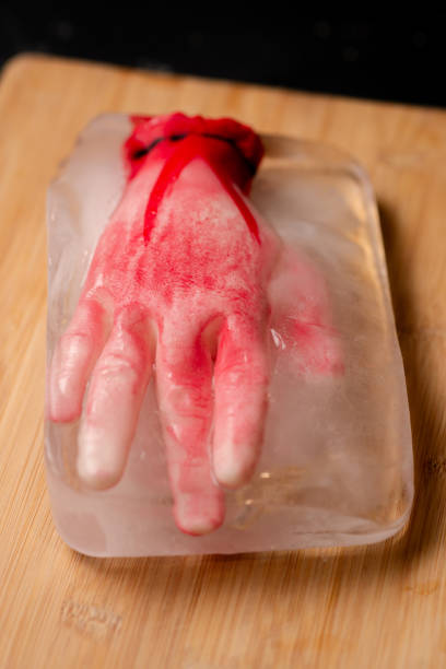 Ice-cold horror: A conceptual horror image with an artificial human hand frozen within an ice block, creating an eerie and suspenseful atmosphere Ice-cold horror: A conceptual horror image with an artificial human hand frozen within an ice block, creating an eerie and suspenseful atmosphere suspenseful stock pictures, royalty-free photos & images
