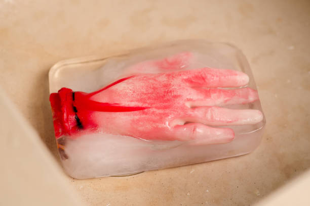 Ice-cold horror: A conceptual horror image with an artificial human hand frozen within an ice block, creating an eerie and suspenseful atmosphere Ice-cold horror: A conceptual horror image with an artificial human hand frozen within an ice block, creating an eerie and suspenseful atmosphere suspenseful stock pictures, royalty-free photos & images