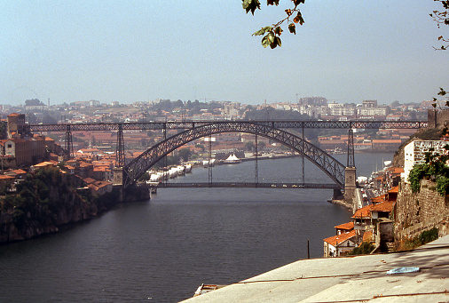 Porto, Portugal - aug 5, 1993: panoramic view of the Douro river with the Dom Luis iron bridge crossing it, in Porto, Portugal