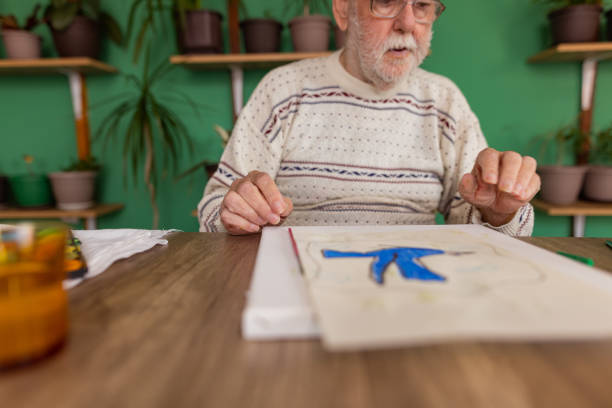 istock Male artist paints on a canvas in his studio 1814905797