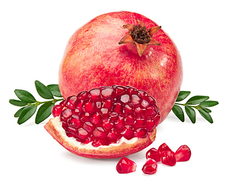pomegranate fruit with green leaves and seeds isolated on a white background. clipping path