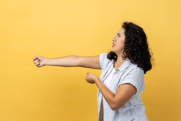 attractive hard working woman standing and doing pulling gesture of something. - imagination fantasy invisible women imagens e fotografias de stock