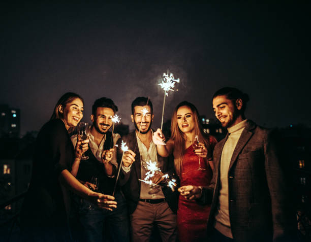 istock friends celebrate the new year on the rooftop 1814913152