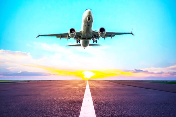 istock passenger plane flies over the runway. air transport industry 1814913233