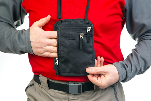 Male tourist with a waist bag for things and documents on a trip. belt bag with a zipper for things and documents while traveling