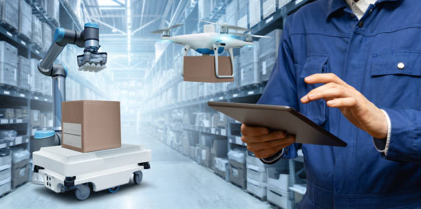 istock Manager with digital tablet in an automated warehouse with robots and drones 1814914730