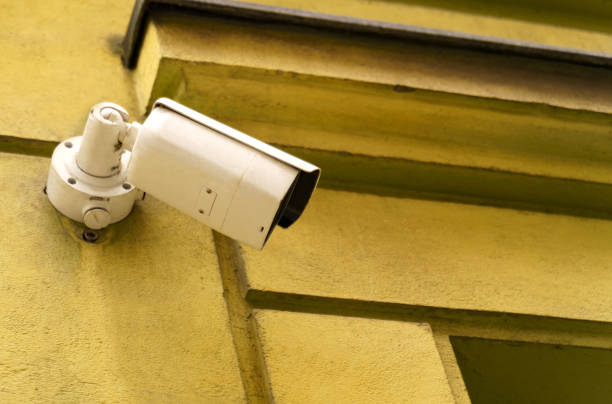 istock Surveillance camera installed on the wall of an old building. 1814918112