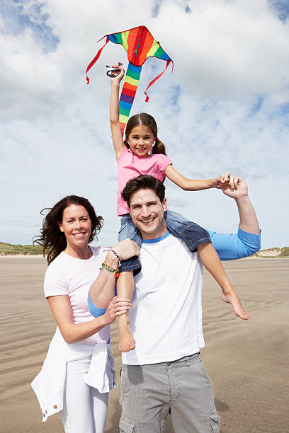 istock Family Having Fun Flying Kite On Beach Holiday 181492619