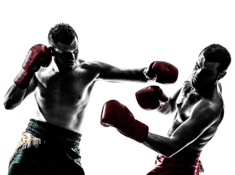 Caucasian male boxers practicing in a gym.Entering a ring for a sparring practice. Working hard in a boxing gym, sweating.