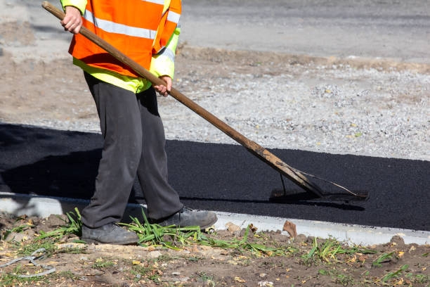 istock workers lay fresh asphalt on the sidewalk. road industry 1814942234