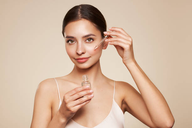 istock Young beautiful woman applying face serum 1814954465