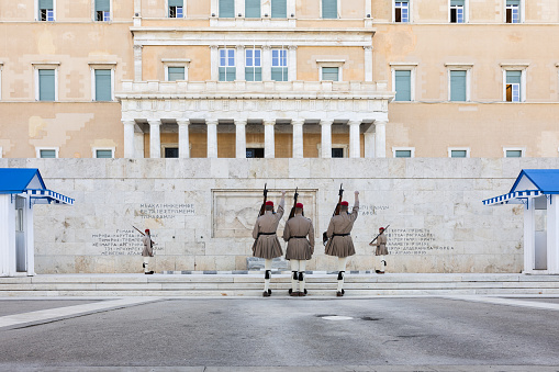 Athens, Greece - October 13, 2023:  Changing of the presidential guard (Evzones) on Syntagma Square in the center of Athens, (Greece) opposite the tomb of the Unknown Soldier and Parliament building.