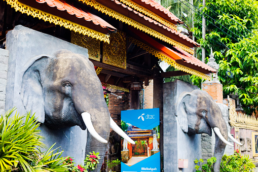 Entrance to Oubkham Museum in Chiang Rai. At both sides of gat are elephant sculptures. There is also a sign for thai telecommunication company dtac. Museum is located 81/1 Nahkhai Rd, Tambon Rop Wiang, Mueang Chiang Rai District, Chiang Rai 57000