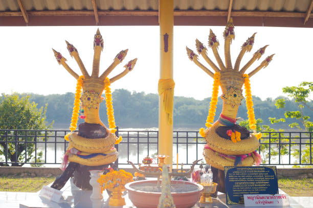 Golden thai Nakhon shrine at Mekong river in Chiang Khong. Two statues are placed under a roof