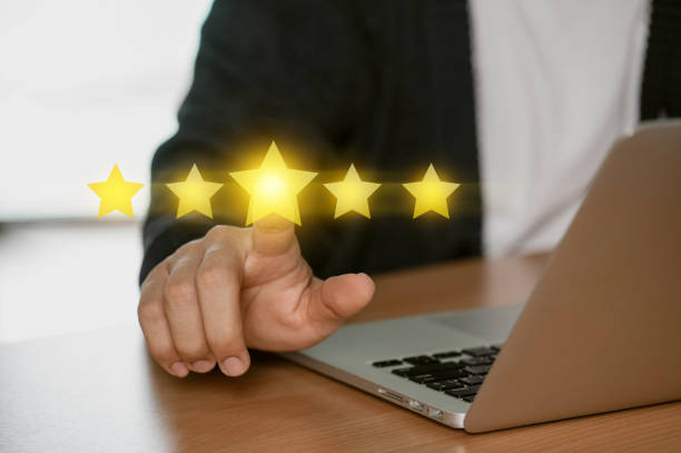 istock User give five star rating using a laptop on the online application for the customer review satisfaction feedback survey idea, users rate their service experience. 1814967162